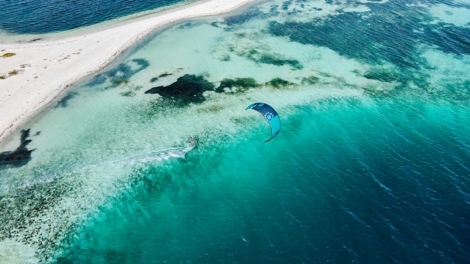photo of a person surfing with the kite